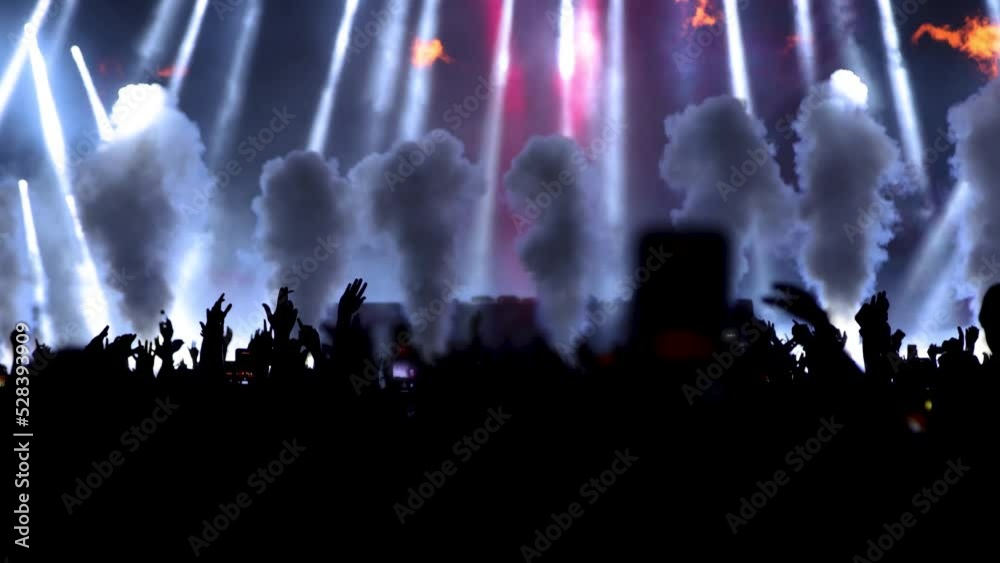 Flame and smoke on the DJ party concert stage, silhouettes of fans with hands up