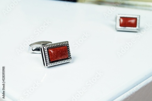 Macro silver red men sleeve button isolated shiny glitter stone in metal cuff link male accessory photo