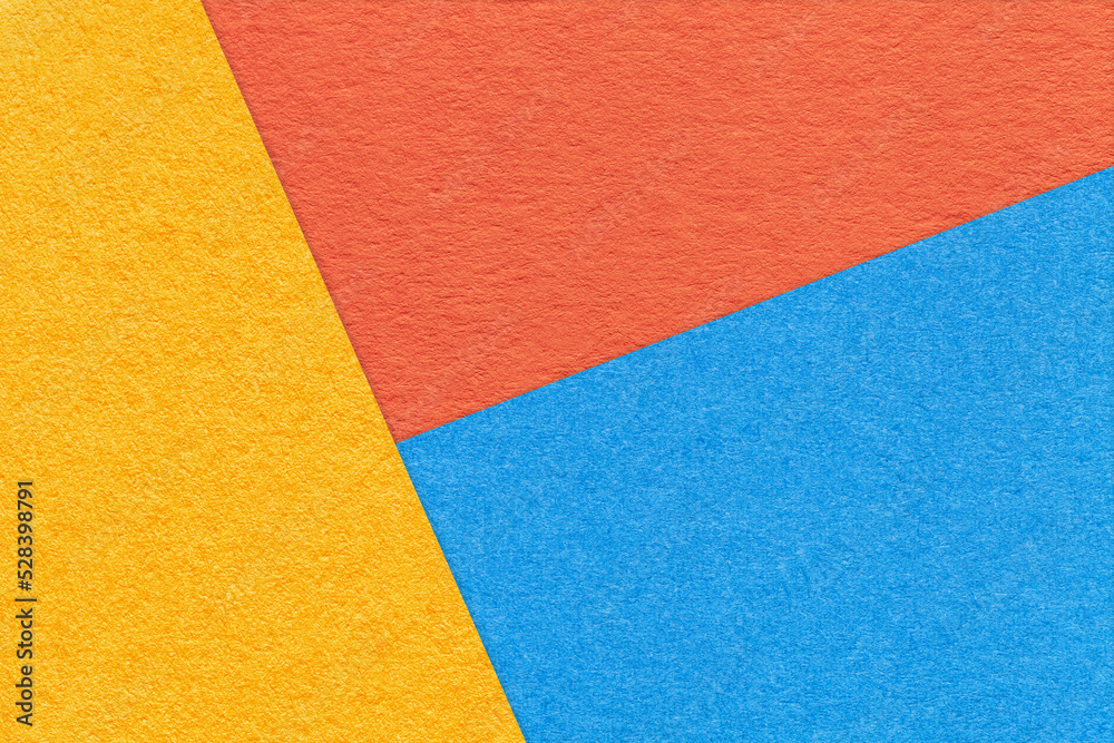 Texture of craft yellow, blue and orange shade color paper background. Structure of vintage abstract cardboard Texture of craft yellow, blue and orange shade color paper background. Structure of vintage abstract cardboard