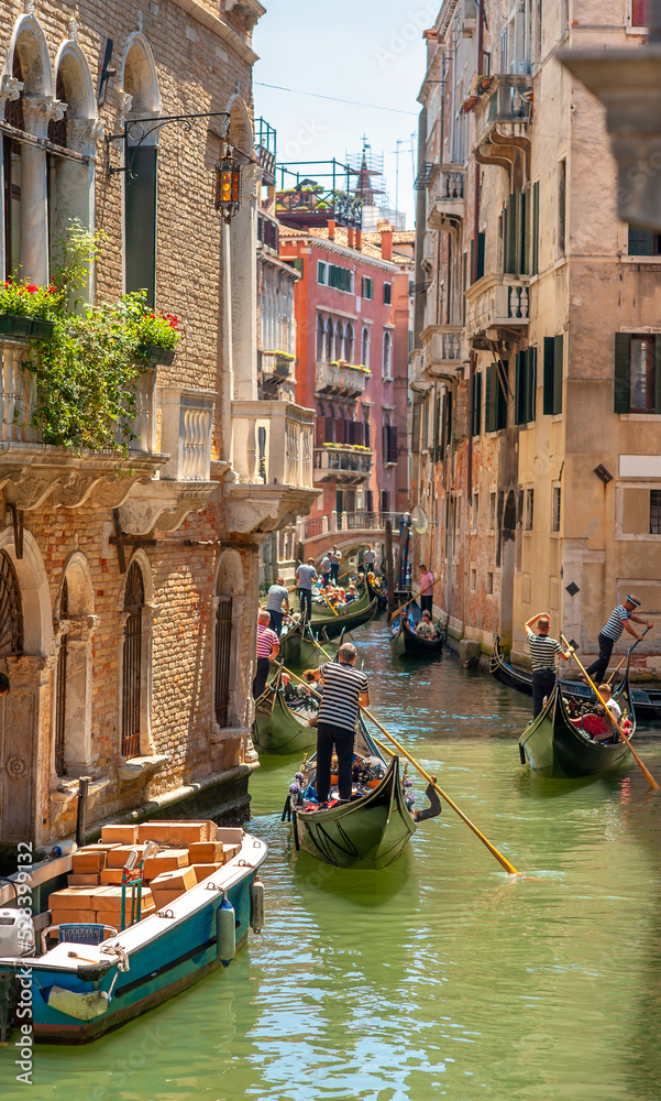 View on the narrow cozy streets of the canals with gondolas one of the symbols of Venice, Italy. Architecture and landmark of Venice.