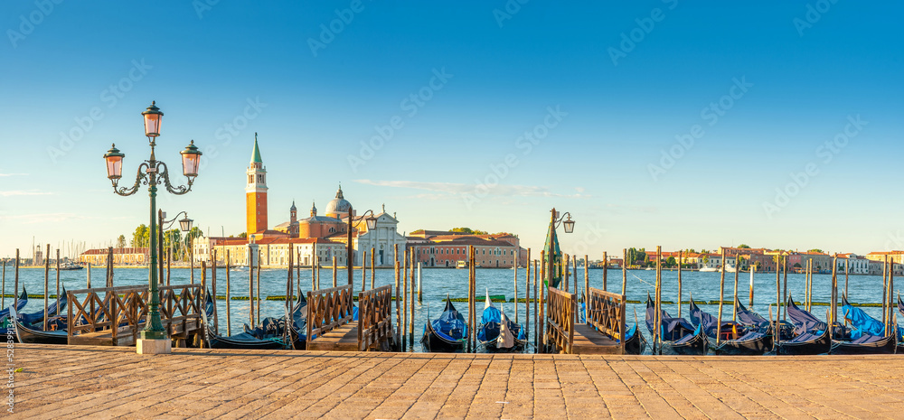 Panorama of the Grand Canal with gondolas one of the symbols of Venice against the backdrop of San Giorgio Maggiore church at dawn, Italy. Architecture and landmark of Venice.