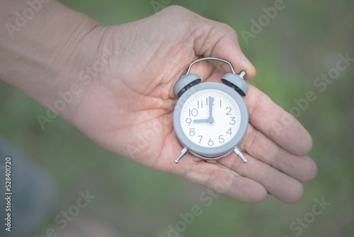 Concept image of elderly hand holding a watch