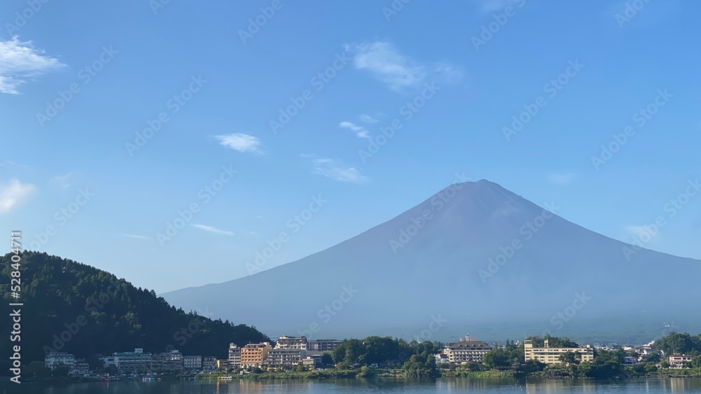 The balcony view of the Mt. Fuji in the summer, the beautiful clear silhouette and the sunny reflections of the lake of Kawaguchiko, year 2022 August 27th, Yamanashi prefecture, Japan

