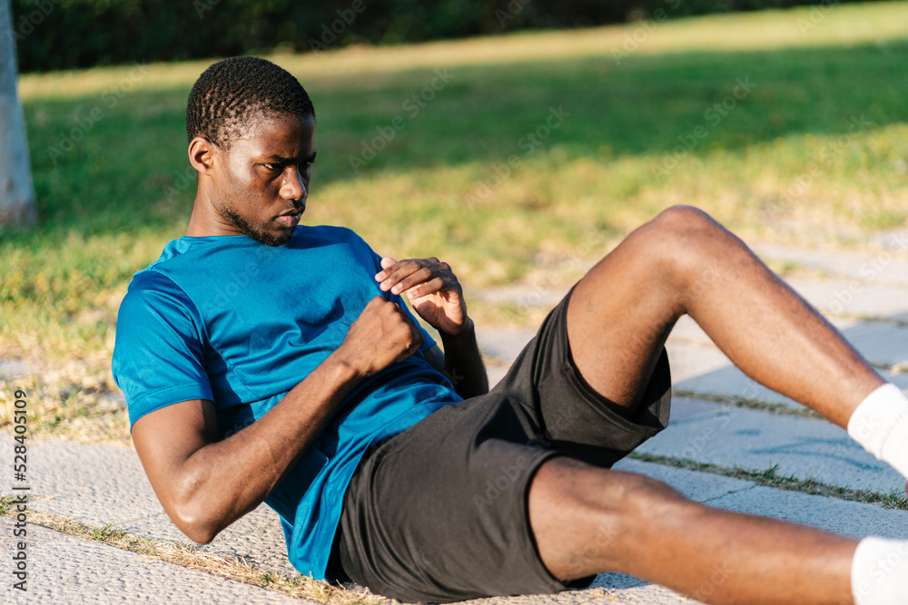 Young man exercising at park on sunny day Young man exercising at park on sunny day