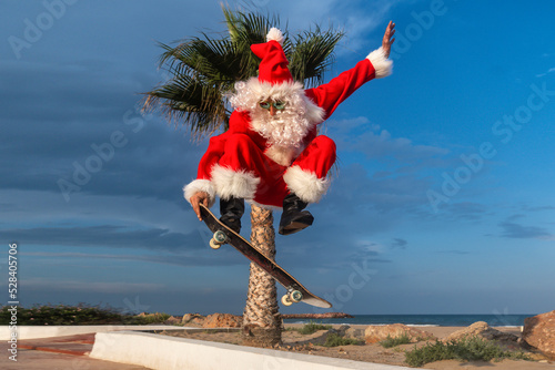 Mature man wearing Santa Claus costume skateboarding on footpath