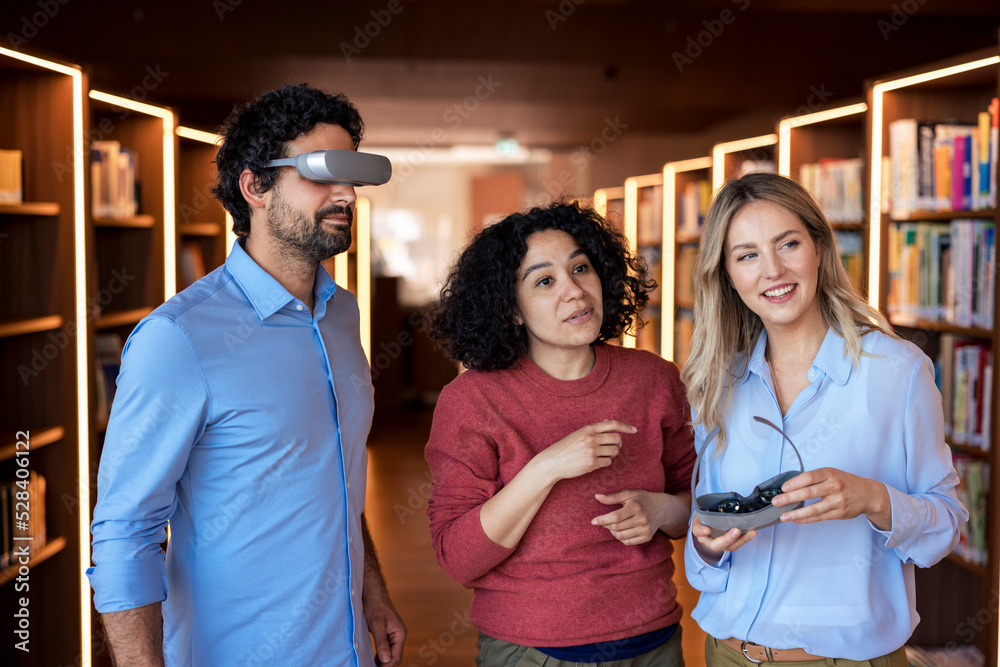 Professor watching through smart glasses standing by colleagues in ...