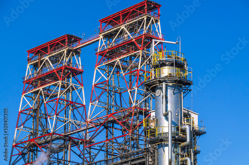 Fractionating column at an oil refinery. Production equipment at a petrochemical plant. Oil refining production. Production of chemical components and gasoline.
