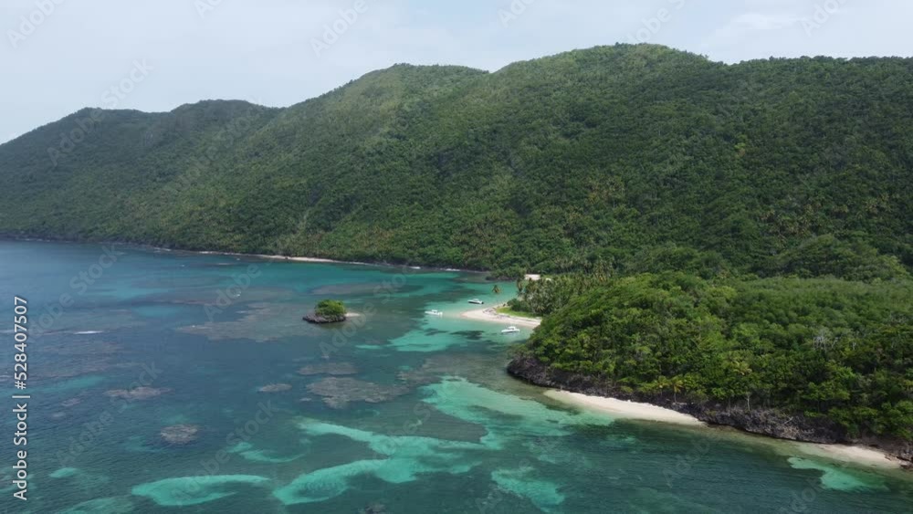 Color contast of blue and turquoise sea water with green lush rainforest at Playa El Ermitano beach in Samana Bay, Dominican Republic. Aerial drone view Color contast of blue and turquoise sea water with green lush rainforest at Playa El Ermitano beach in Samana Bay, Dominican Republic. Aerial drone view