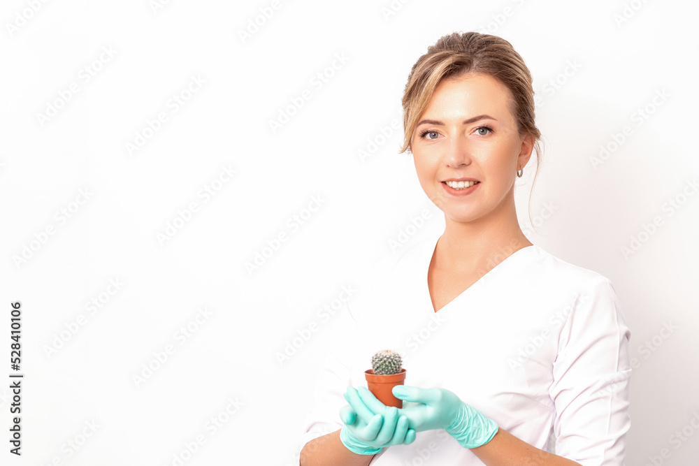 A portrait of a smiling female holds little green cactus in her hands. Hair removal concept A portrait of a smiling female holds little green cactus in her hands. Hair removal concept