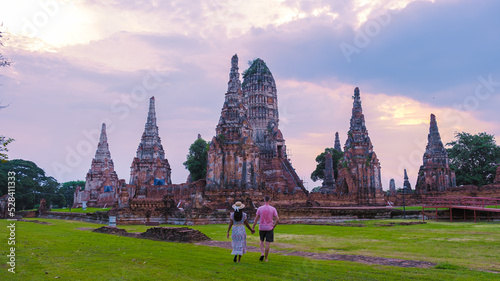 Men and Women with hat tourist visit, Ayutthaya, Thailand at Wat Chaiwatthanaram during sunset in Ayutthaya Thailand. Couple on a trip to the old city of Ayutthaya photo