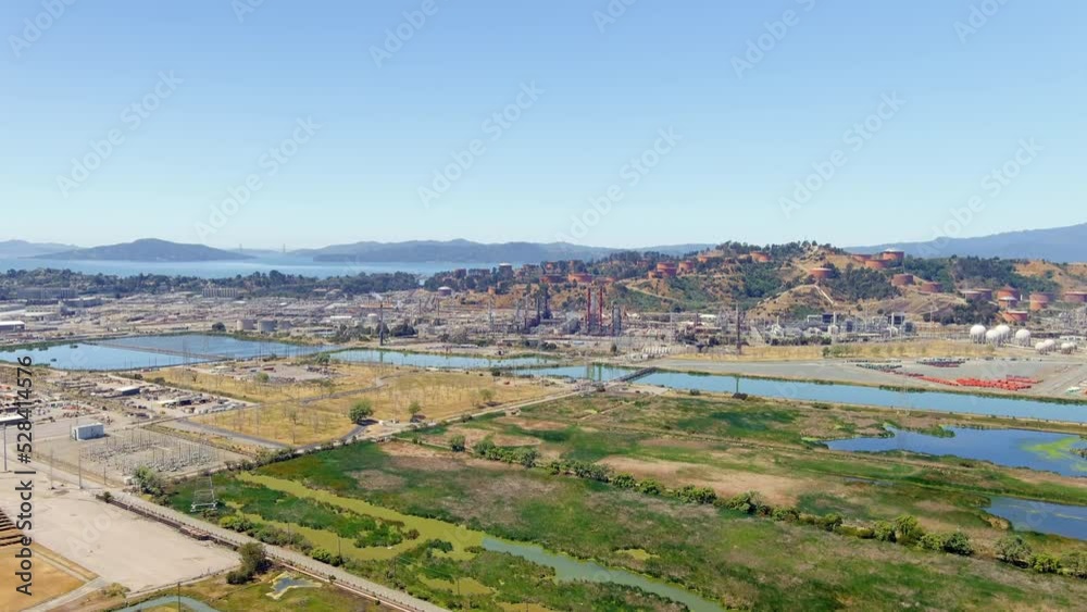 Aerial view of Dutra materials company factory in the bay in California. Drone view of large industrial facility on the coast
Aerial view of Dutra materials company factory in the bay in California. Drone view of large industrial facility on the coast