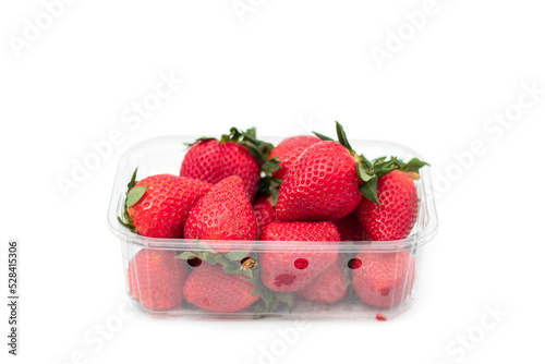 Fresh strawberries in plastic box, isolated on white. Produce product of agriculture industry