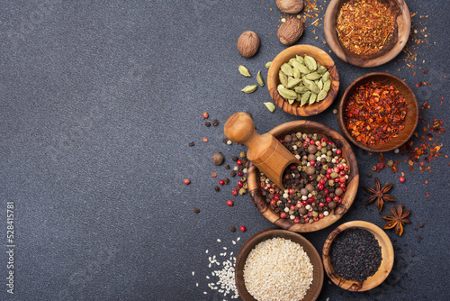 Different spices or seasonings in wooden bowls for tasty meals