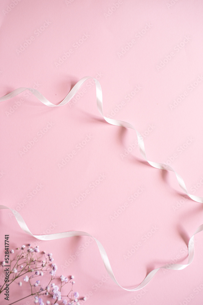 Pink tablet for text with a background of white flowers and ribbon Pink tablet for text with a background of white flowers and ribbon