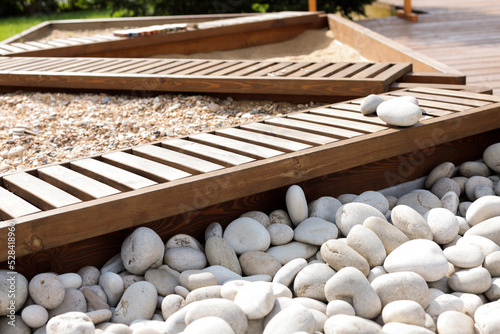 A sensory garden with rocks, bark and sand. Close-up, selective focus