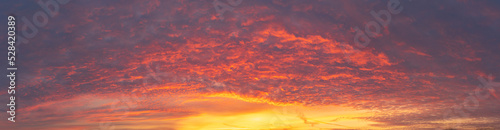 Stunning panoramic shot of clouds reflecting a magnificent sunset. Sky serving as the background. Copy space © MKozloff
