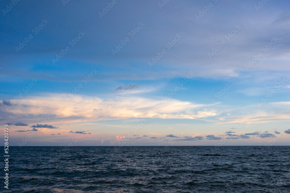 seascape with sunset against blue sky
