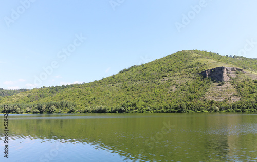 Landscape on the banks of a big river with calm water. Dniester river tributary, Ukraine.