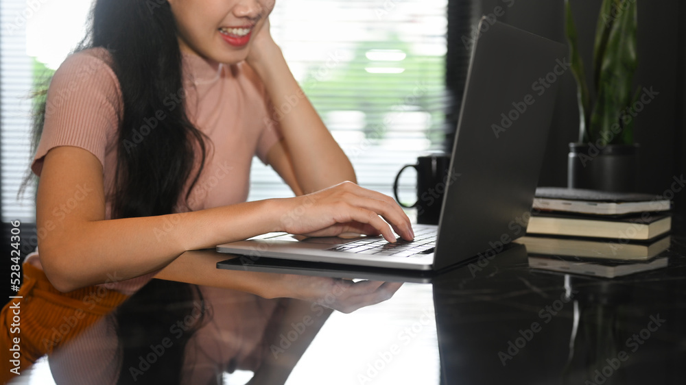 Cropped shot of young lady freelancer remote working from home with laptop computer Cropped shot of young lady freelancer remote working from home with laptop computer