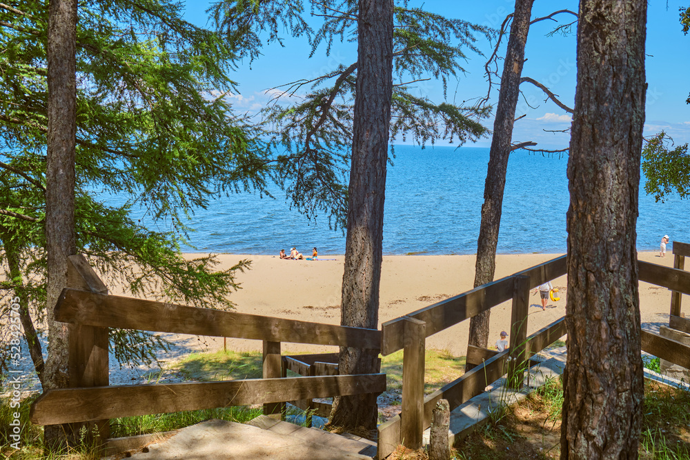 Lake Baikal coast, hill with forest, water bay. Summer travel, discovery of beauty of Earth. Siberia, Russia. Lake Baikal coast, hill with forest, water bay. Summer travel, discovery of beauty of Earth. Siberia, Russia.