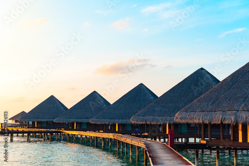 Fotografie, Tablou picturesque view of the water villas at sunrise in the Maldives, the concept of