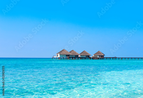 wooden pier in the sea at day time with blue sky and beautiful clouds in the Maldives  the concept of luxury travel