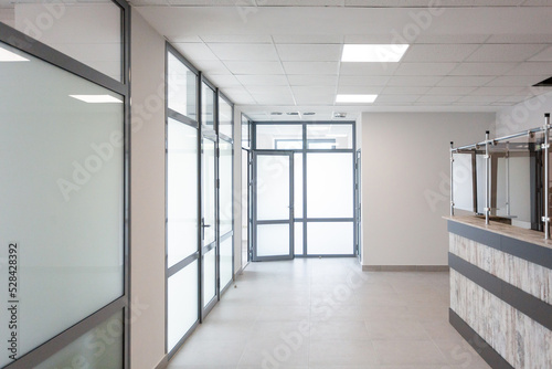 Stylish minimalist office corridor with empty receptions in modern coworking center.