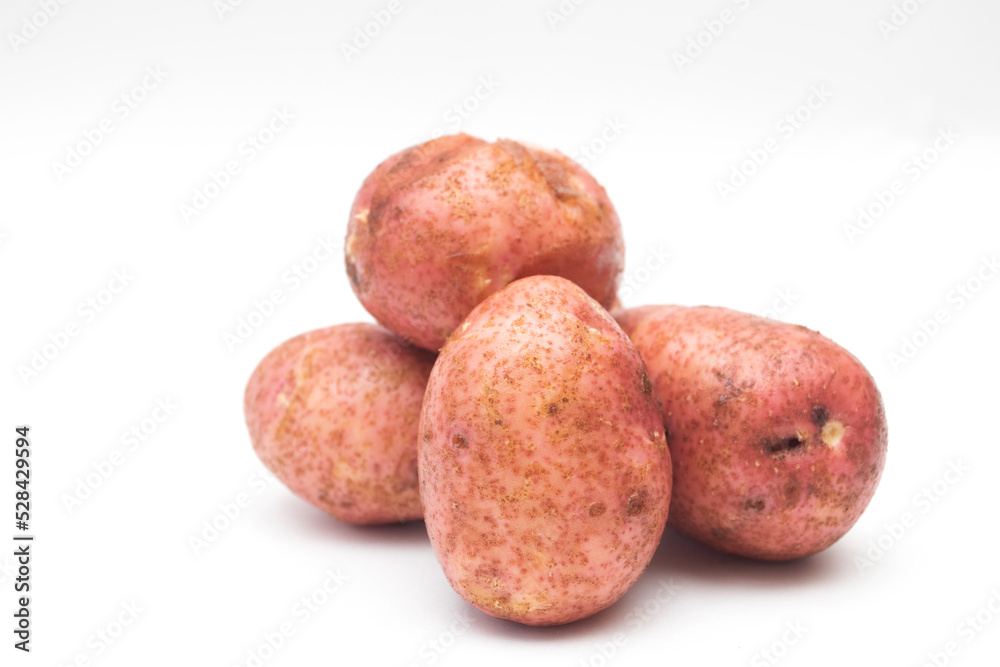 Fresh red raw potatoes on a white background Fresh red raw potatoes on a white background