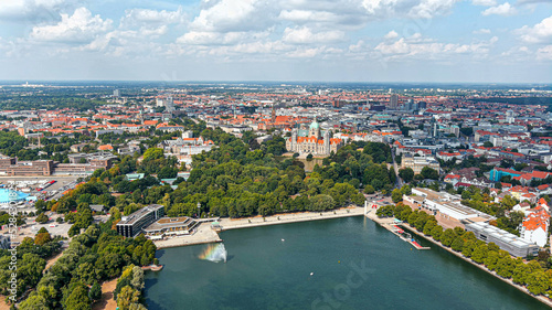 Fototapeta Naklejka Na Ścianę i Meble -  New Town Hall (Neues Rathaus) and Hannover city center aerial view, Germany, Europe. Aircraft point of view aerial shot ft. Maschsee Lake and parks around Hanover-Mitte, the historic heart of the city