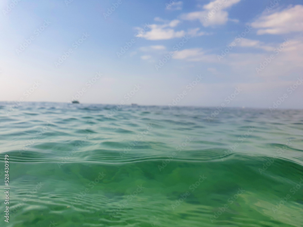 Ocean sea water level with cloudy blue sky background landscape