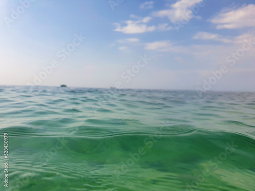 Ocean sea water level with cloudy blue sky background landscape