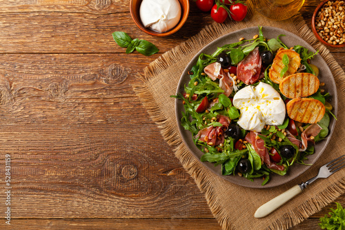 Salad with burrata cheese and croutons.