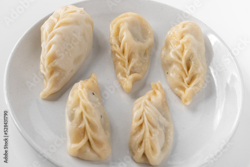 Traditional Dumpling Momos Served on white plate.
