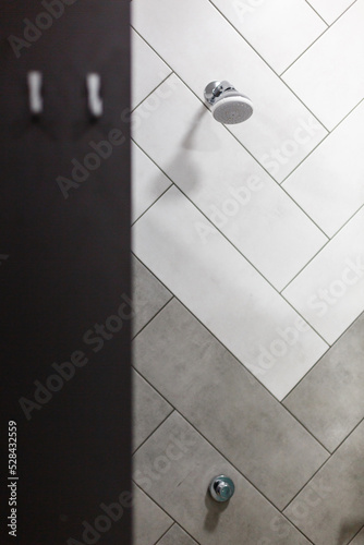 Stylish minimalist shower head built into wall in modern bathroom.