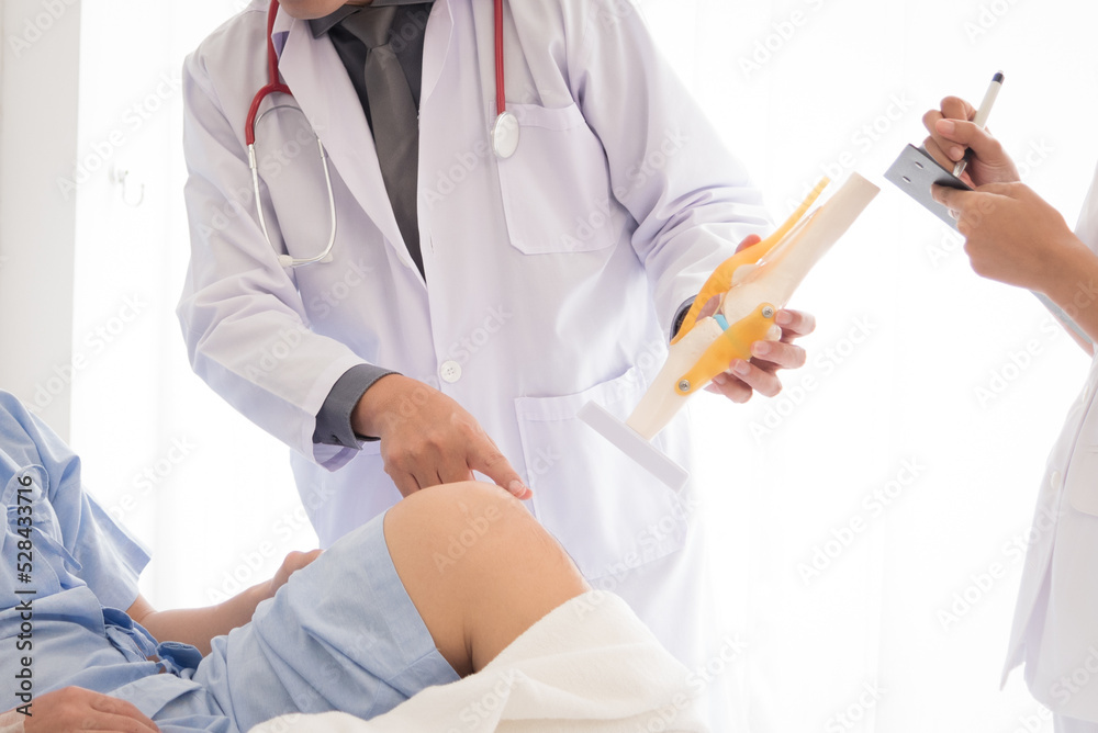 Doctor in professional working uniform taking care his patient and diagnosis symptoms on the bed.