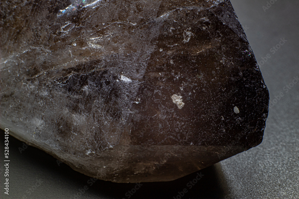 Macro gray brown smoky quartz natural point isolated on black surface