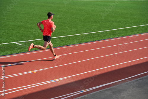 Sport man athlete is running on treadmillat the stadium