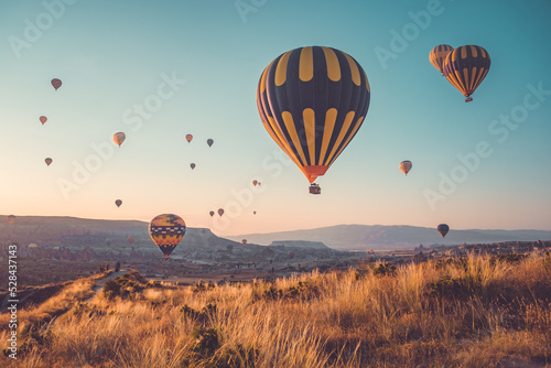 Sunrise tourists attraction on hot air balloons in Cappadocia. Sunset hill panoramic view. Best famous travel locations. Natural summer scenery, adventure concept. Colorful morning scene background