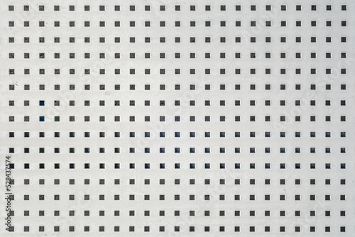 abstract background of perforated metal sheet painted in white