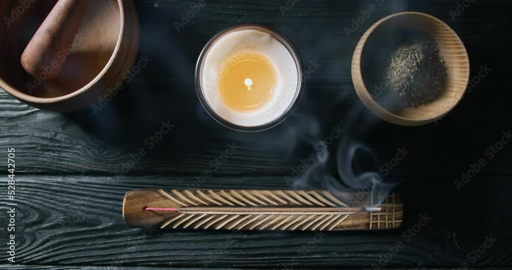 Incense stick smoldering in holder on black wooden table. Flat lay Incense stick smoldering in holder on black wooden table. Flat lay