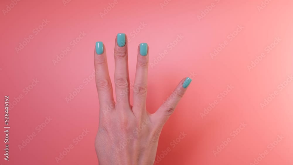 Close up of womans hand counting to five with her fingers.