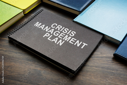 Crisis management plan and notepads on the desk.