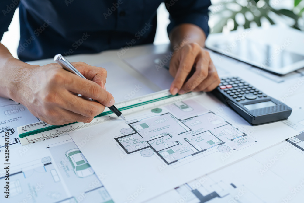 Close-up, architects team are brainstorming, designing and drawing the structure of the building. Close-up, architects team are brainstorming, designing and drawing the structure of the building.