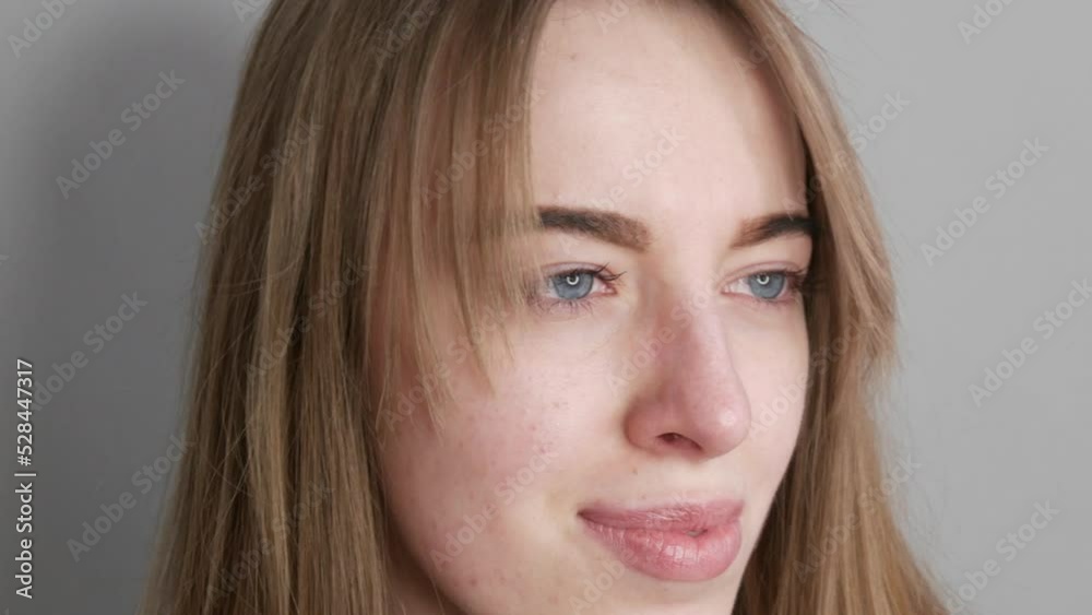 Young girl with blue eyes without makeup posing for the camera Young girl with blue eyes without makeup posing for the camera