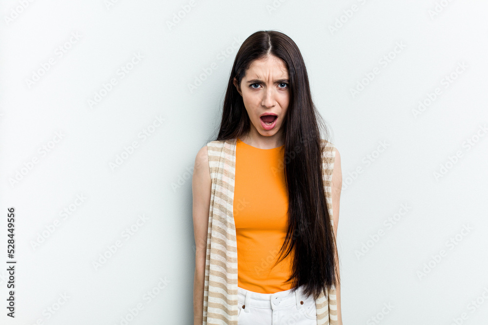 Young caucasian woman isolated on white background shouting very angry, rage concept, frustrated. Young caucasian woman isolated on white background shouting very angry, rage concept, frustrated.