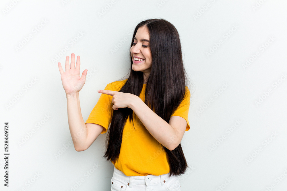 Young caucasian woman isolated on white background smiling cheerful showing number five with fingers. Young caucasian woman isolated on white background smiling cheerful showing number five with fingers.