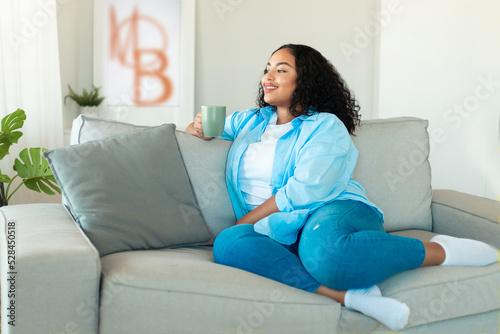 African American Woman Drinking Coffee Sitting On Couch At Home Free Download African American Woman Drinking Coffee Sitting On Couch At Home - GFXLoad