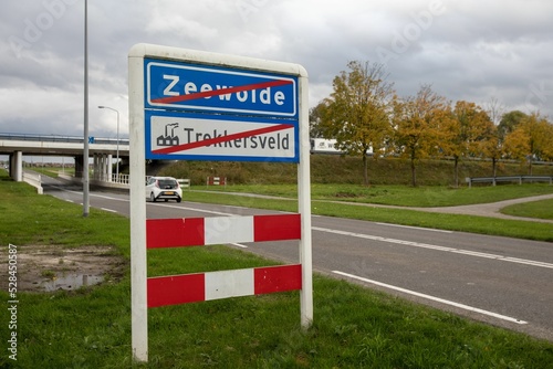 Road sign of Zeewolde with red cross on it on highway in the Netherlands photo