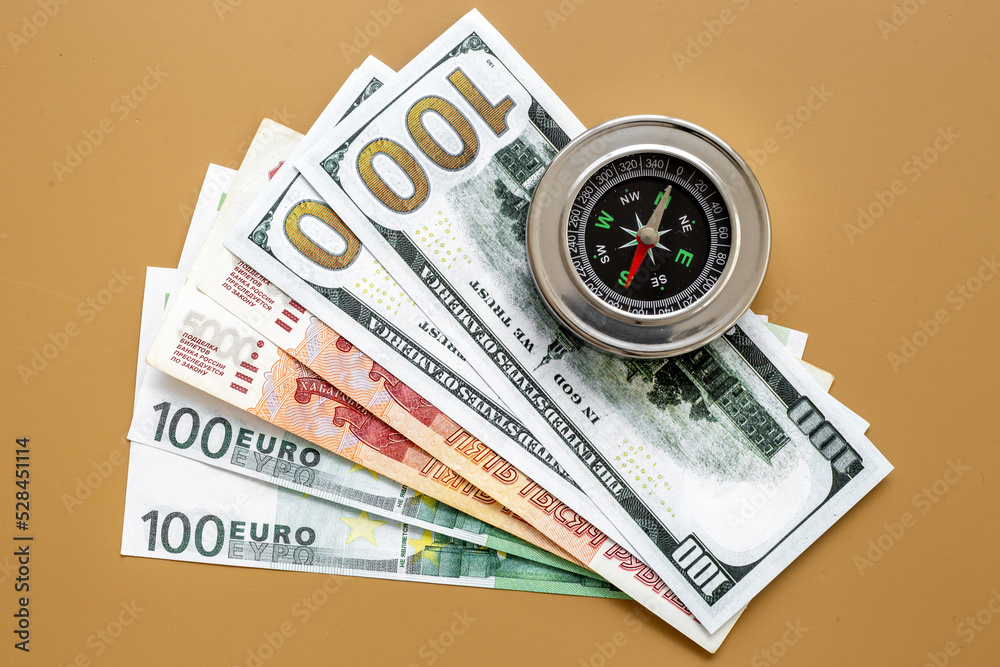 Compass and money cash. Exchange quotes of currencies concept Compass and money cash. Exchange quotes of currencies concept