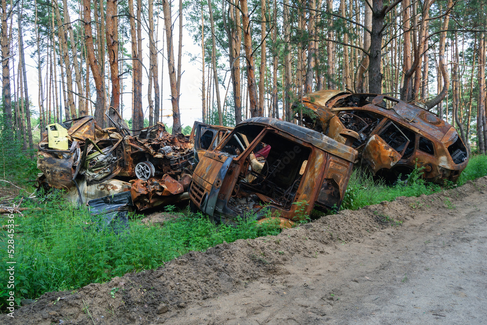 burnt cars. pile of scrap metal. consequences of the war. Irpin, Bucha, Gostomel